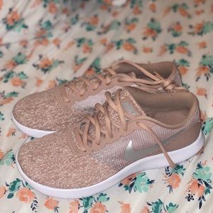 Rose gold woman’s Nike running shoes